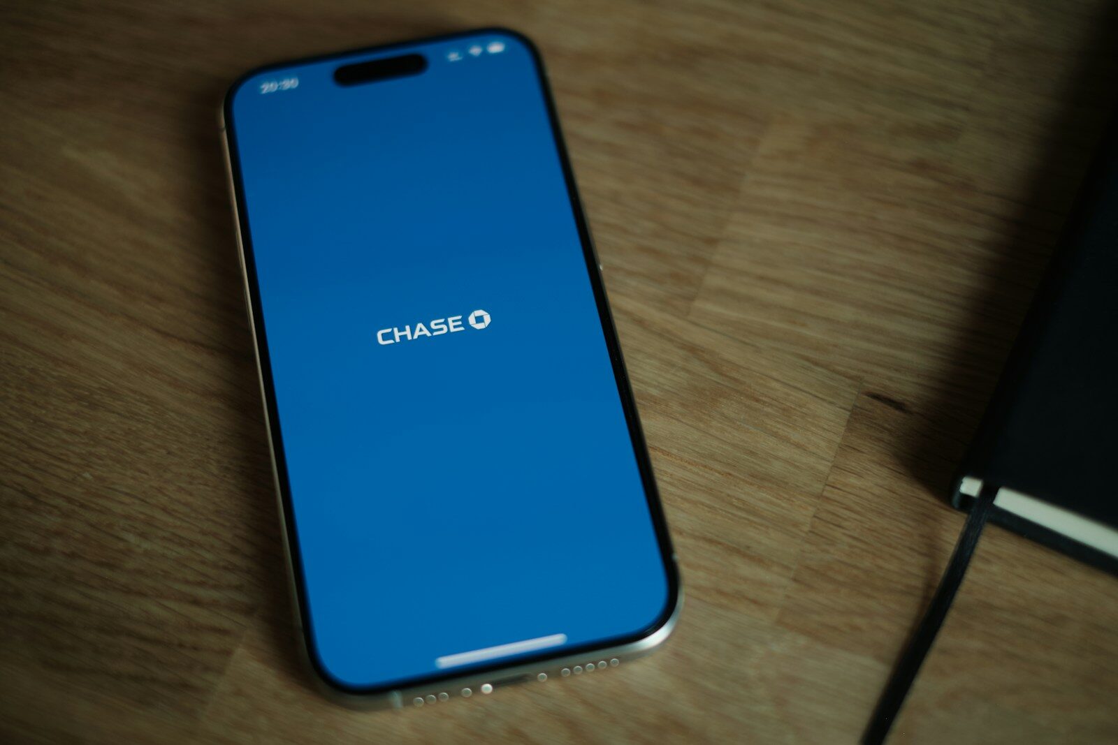 A cell phone sitting on top of a wooden table