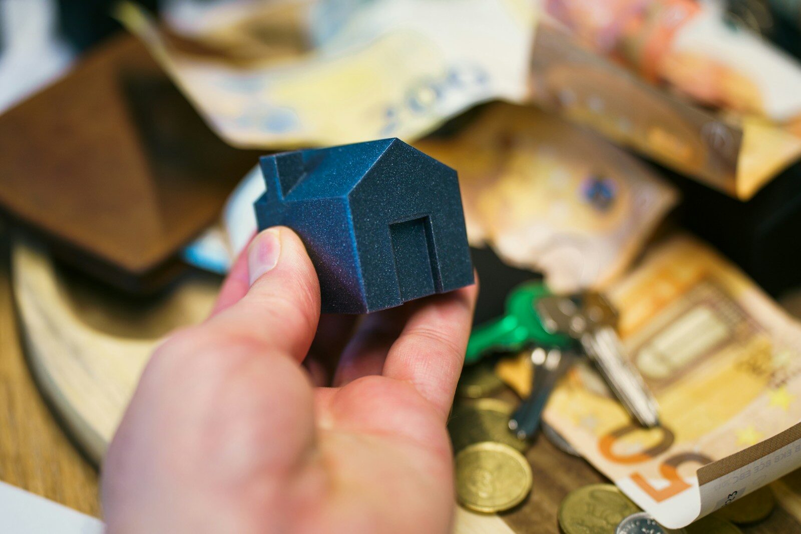 Buying a house with money, keys, and coins
